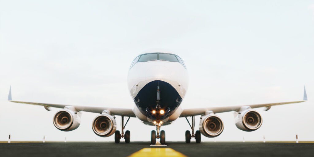 White commercial airplane standing on the airport runway at sunset. Front view of passenger airplane is taking off. Airplane concept 3D illustration.